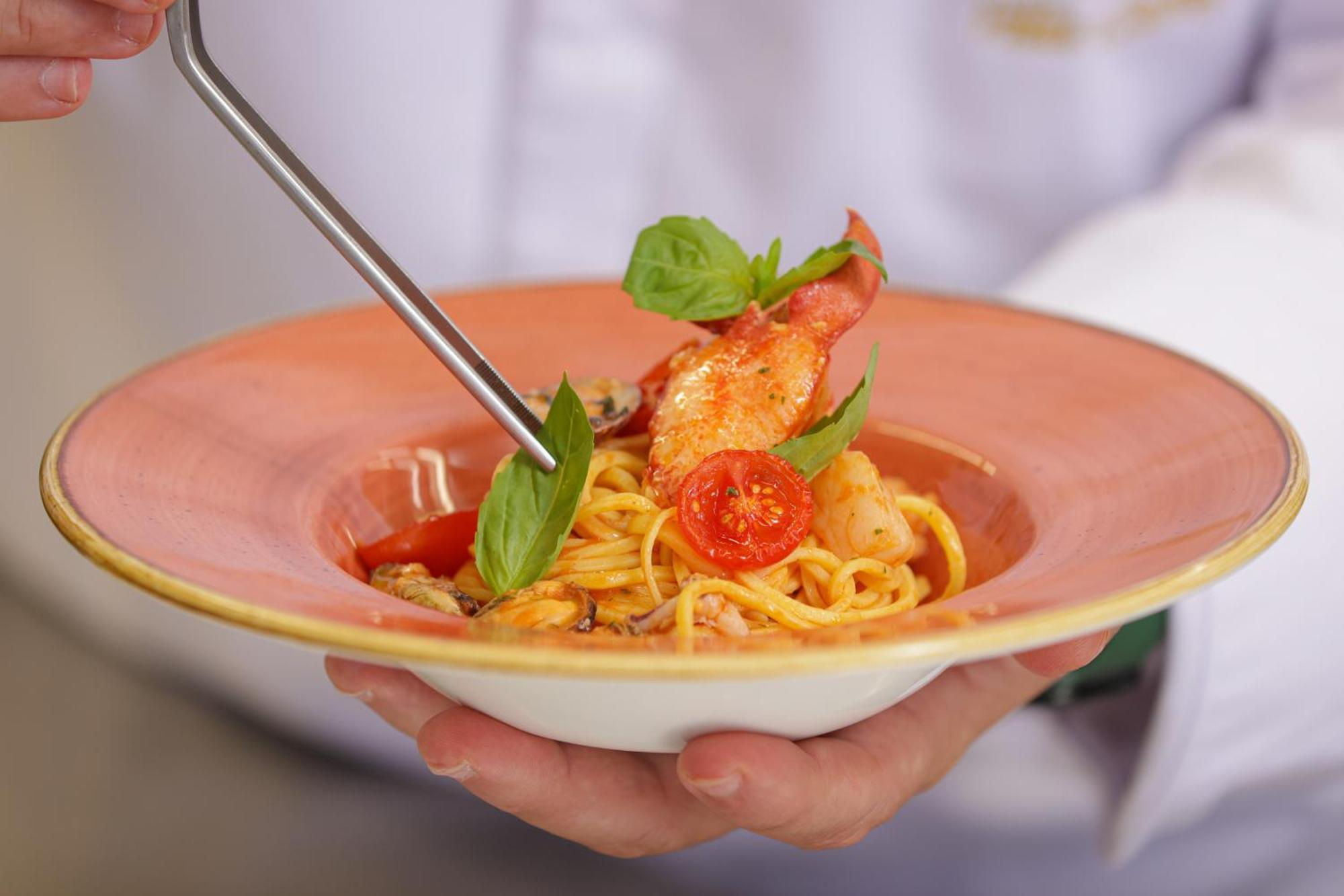 Grand Hotel Villa Castagnola Lugano Ngoại thất bức ảnh A chef finishing a pasta dish